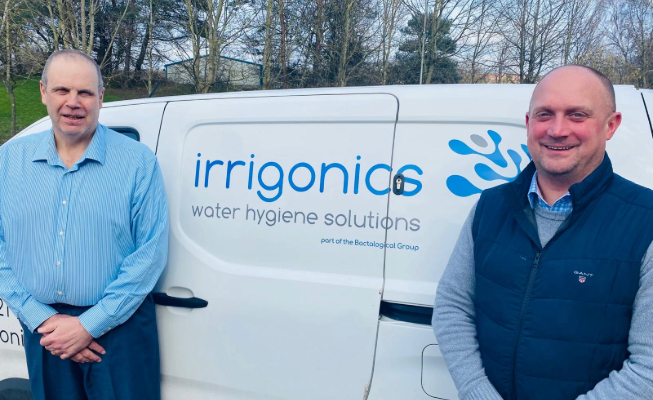 Dale Hunter and Phil White stand in front of branded Irrigonics van